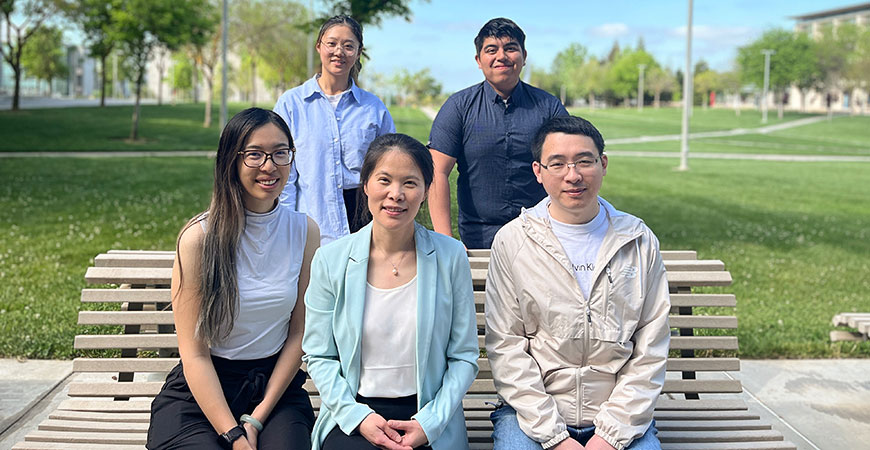 Xuecai Ge, center, and her students