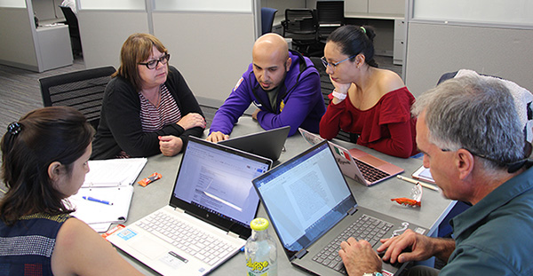 A group of Luce Foundation fellows work together in Professor Robin DeLugan's Interdisciplinary Humanities course. From left to right: Ekta Kandhway, Robin DeLugan, Alfredo Gaona, Miriam Campos Martinez, and Scott Nicolay.